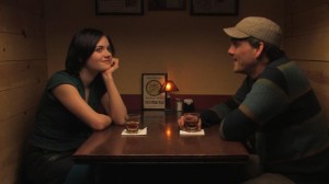 Betty and Jared (Meredith Adelaide and Bryce Flint-Somerville) flirt in a bar in a scene from Did You Kiss Anyone?